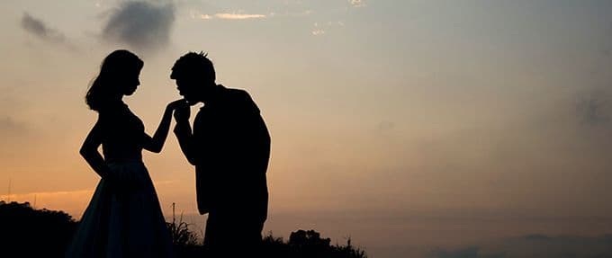 silhouetted couple at sunset