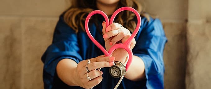 doctor holding stethoscope as heart