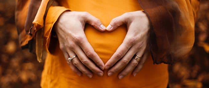 pregnant woman with heart over belly