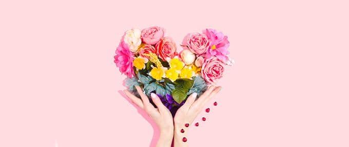 hands holding flowers shaped like heart